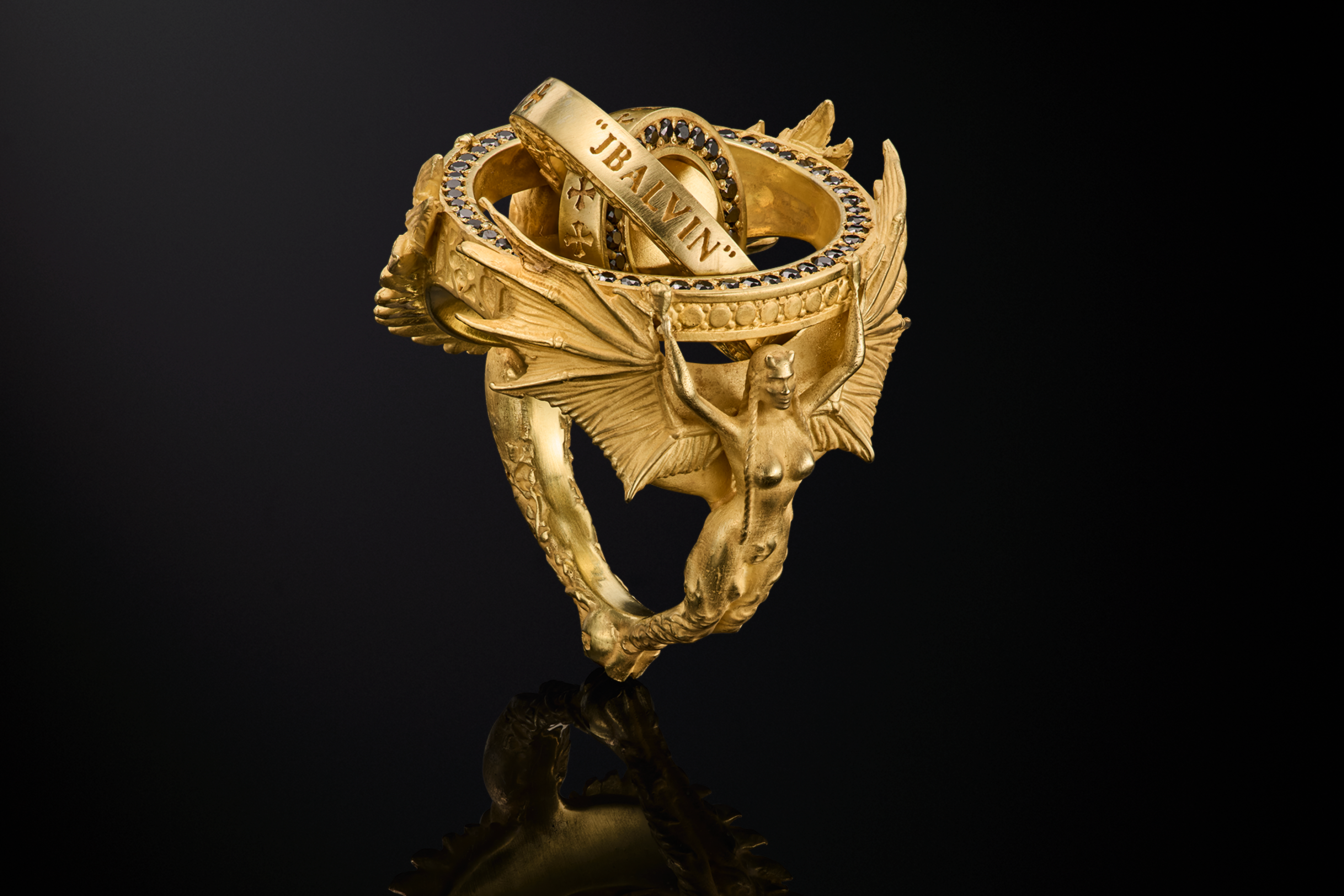 Heaven & Hell ring (I/II), 18K gold with black diamond micro-pavé, created for J Balvin. Three-quarter view (Hell side) with “JBALVIN” engraving.